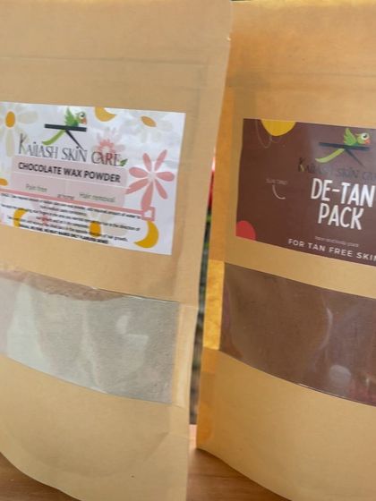My two popular powder products side-by-side: the Chocolate Wax Powder for hair removal and the De-Tan Pack for tan-free skin. Both are made with natural ingredients and come in earth-friendly packaging.