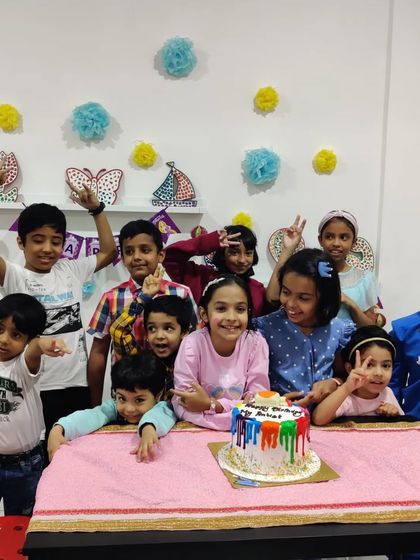 Another fantastic birthday celebration at the studio! Look at all those happy faces ready to dig into a colorful birthday cake.