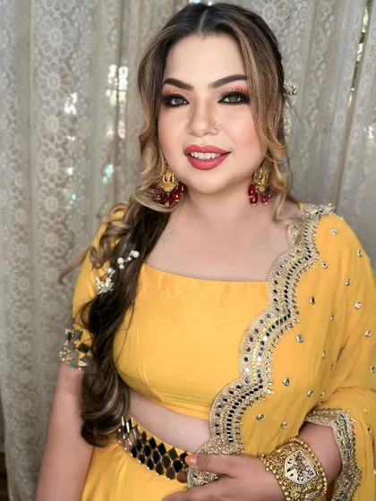 A close-up of the bride's glamorous Mehendi look. I created a bold smokey eye and a bright red lip to match her vibrant personality.
