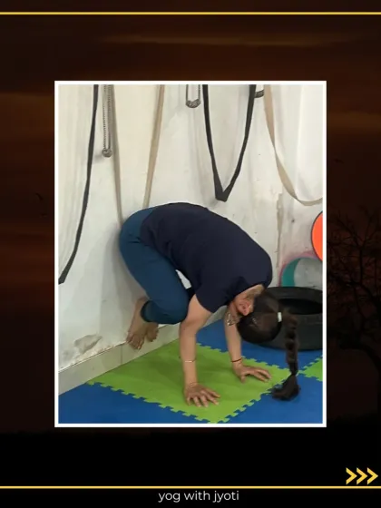 A student practices Crow Pose using the wall to build confidence and find her balance point.