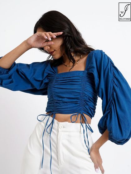 A close-up detail shot that highlights the ruching and tie-strings on the blue top, an important feature for online shoppers.