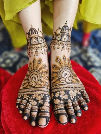 Your bridal mehendi is complete only with beautifully decorated feet. This design features majestic peacocks with fanned tails, complemented by architectural dome motifs on the ankles.