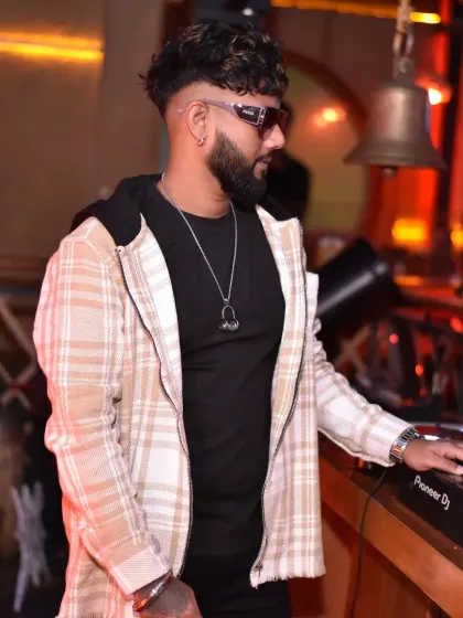 A stylish pose in a plaid jacket. I believe in spreading love and good music wherever I go.