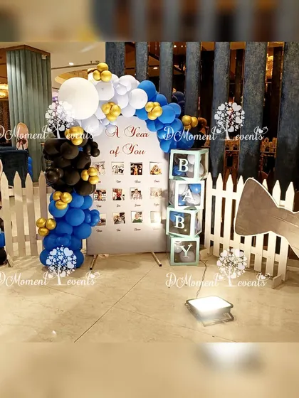 A wider view of the milestone photo display area, complete with a white picket fence and a Boss Baby character cutout.