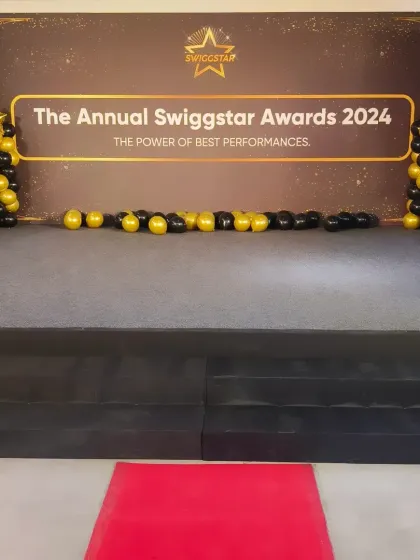 Here is the main stage setup for the Annual Swiggstar Awards 2024. We provided a complete solution including the branded backdrop, a professional stage with a red carpet, and decorative balloon columns to create a prestigious setting for their employee recognition event.