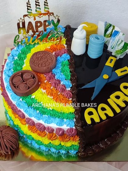 A half-and-half cake celebrating a love for both art and craft. One side is a colorful rainbow, and the other is a rich chocolate design with craft-themed toppers.