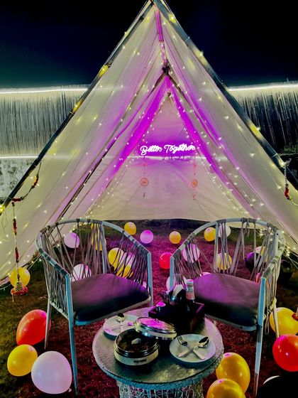 We decorated this tent-style cabana for a special occasion. The "Better Together" neon sign, fairy lights, and balloons create a fun and celebratory private space.