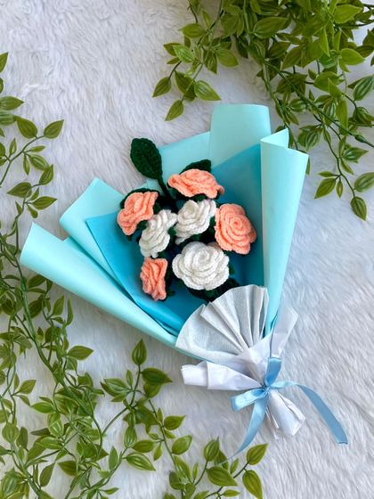 The full view of the meaningful peach and white rose bouquet, set against a backdrop of green leaves. It’s a reminder of how a handmade gift can carry so much emotion.