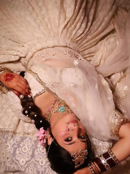 An artistic shot of the bride in our rental lehenga, showcasing the flow and detail of the fabric.