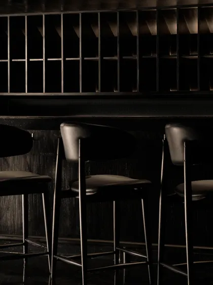 A close-up of the bar chairs, emphasizing their minimalist design.