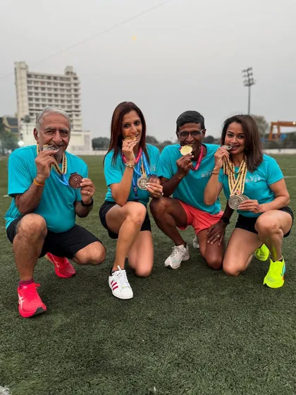 A group shot of our athletes showing off their medals. This picture captures the combined success and team spirit of our running family.