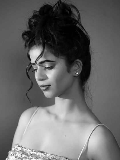 A classic and timeless beauty shot in black and white. Her expression is calm and thoughtful, and the lighting is soft and flattering.