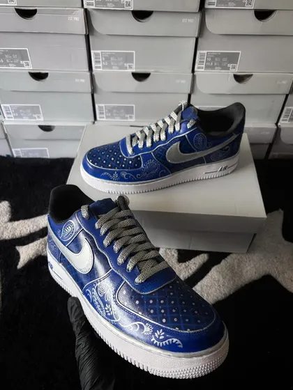 The wedding custom sneakers displayed on their box, showing the metallic silver swoosh.