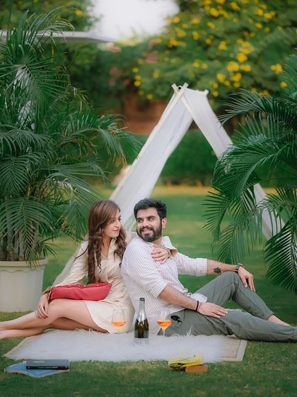 A candid moment of a couple enjoying a picnic on the grass. Our garden sets are perfect for relaxed and natural pre-wedding photos, with props like the airplane and bicycle available to use.