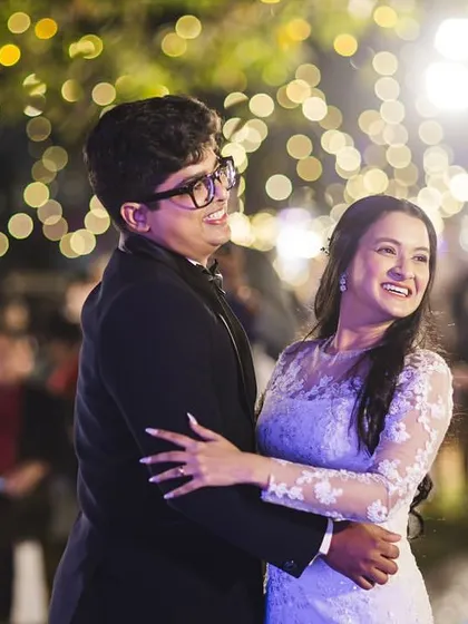 The first dance as a married couple. The bride's makeup is romantic and glowing, perfect for this magical moment under the lights.
