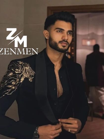 A model getting ready in a black tuxedo with a powerful gold lion embroidered on the shoulder. This is a prime example of creating a personalized, statement piece.