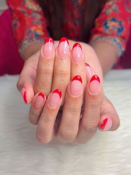 A variation on the red French manicure, with some nails featuring a full color and others a classic tip.