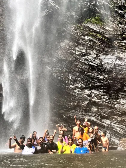 A happy group enjoying a swim in the waterfall pool during our long weekend coastal trip.