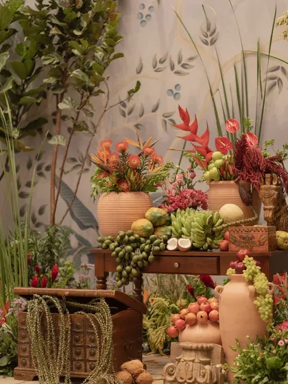 A still life of fruits and flowers from the 'Orchard of Life' event, symbolizing nature's bounty and the sweetness of new beginnings.