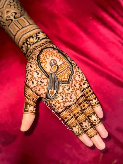A stunning peacock design, with its heart-shaped feather details filling the palm. The peacock is a timeless symbol of grace and beauty in Indian culture.