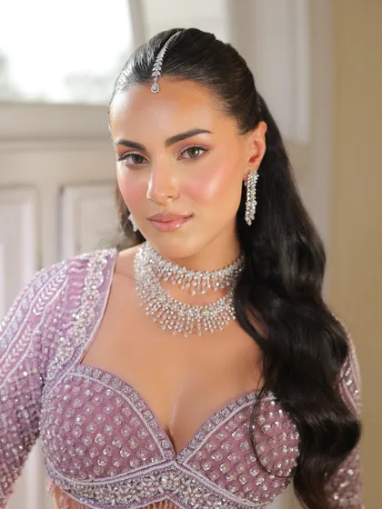 A close-up of the bride's soft, glowing makeup and delicate diamond jewelry. The styling is fresh, modern, and perfect for a summer wedding.