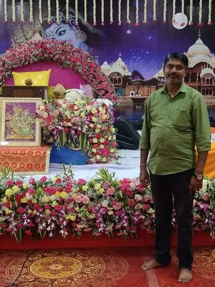 Here I am, Bhupender Kumar, standing proudly in front of a Janmashtami decoration I completed. It is my seva to create these beautiful spaces for the prabhu.