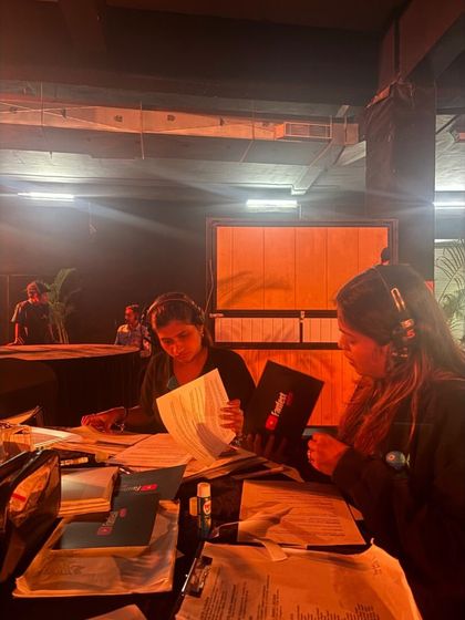 Our show callers reviewing the script and run-of-show for the YouTube Fan Fest. With dozens of segments, meticulous organization is essential.