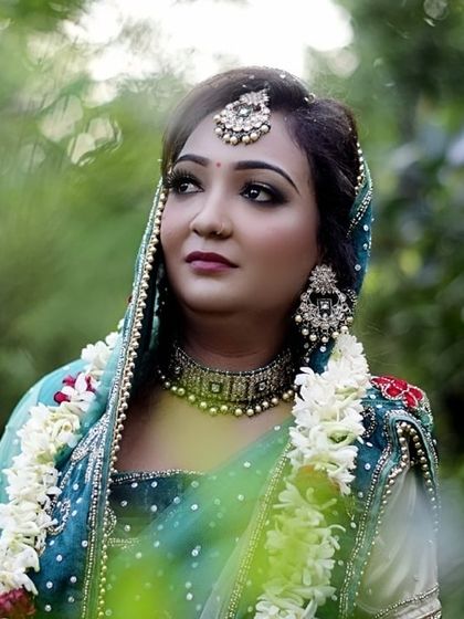 A dreamy, side profile portrait. This photo showcases the contouring and highlight that sculpts the face, as well as the elegant choker and earring set.