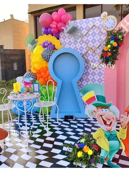 A fun photo booth area with a giant keyhole prop and a checkered floor.