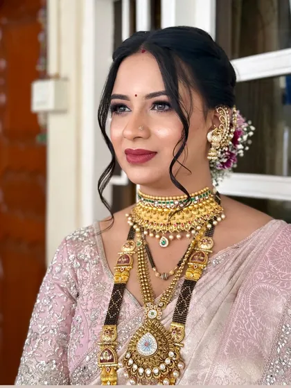 A close-up of a bride's makeup, showing the seamless blend of foundation, the soft contour, and the beautiful sheen on her skin.