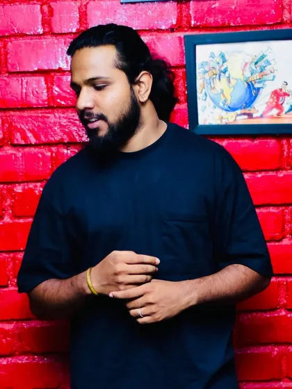A thoughtful pose against a vibrant background. My music is a blend of introspection and high energy celebration.