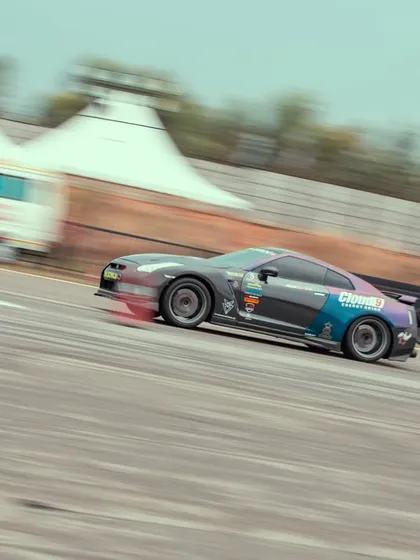 The GTR captured in a dynamic, angled shot, conveying a sense of immense speed and power as it hurtles down the track.