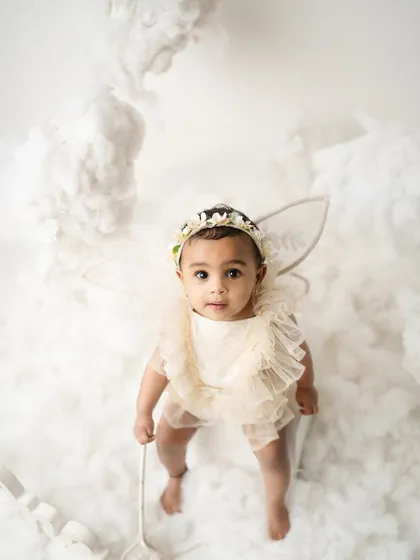 Looking up with innocent eyes, this little angel is ready to fly. I use creative angles to capture the wonder and magic of childhood.