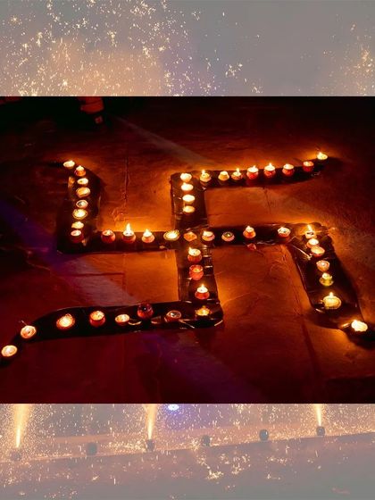 A beautiful arrangement of diyas forming a Swastika, a traditional symbol of good fortune during Diwali.