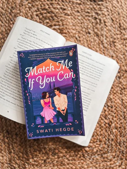 A cozy reader photo of *Match Me If You Can*. This review calls it a "light, delightful read that will bring a smile to your face."