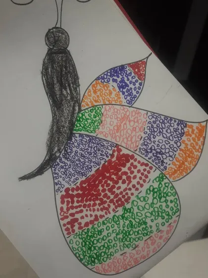 We encourage kids to explore different color combinations in their artwork, as seen in this lovely butterfly drawing.