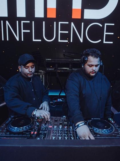 In the zone with my brother DJ Yoschi. We are completely focused on delivering a seamless and powerful set.