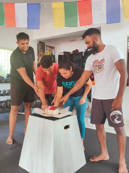 Cutting the cake for our 4th anniversary. We celebrate our milestones together as a team.