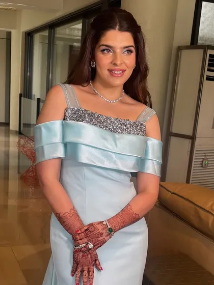 The client looks radiant and happy on her engagement day. Her soft, wavy hairstyle is romantic and timeless.