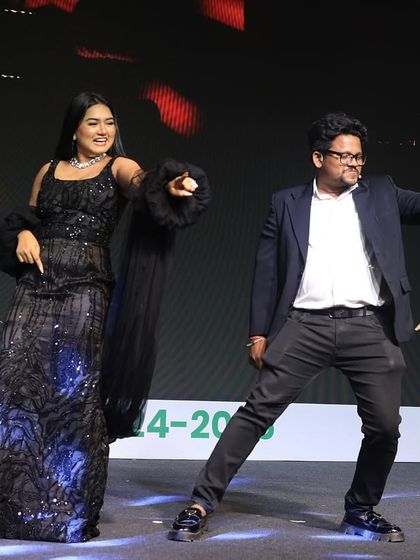 Sharing a fun dance moment on stage during a gala dinner. A good host knows how to get the audience participating, and sometimes that means leading by example with a few moves of my own.