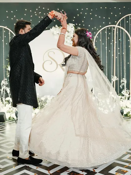 Sukriti and Rahul share their first dance at their glamorous Sangeet. We designed a chic black and white stage with modern arches to create a sophisticated backdrop for their performances.