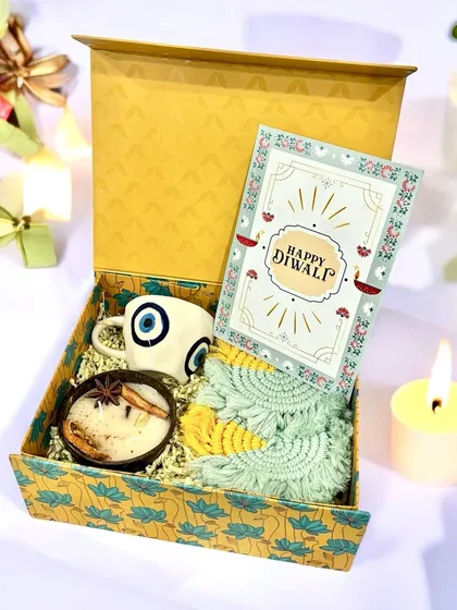 I enjoy creating unique themes, like this "Nurture and Protection" hamper. It combines an evil eye mug to ward off negativity with a hand-poured coconut shell candle and handmade macrame coasters, offering a blend of modern wellness and traditional symbolism.
