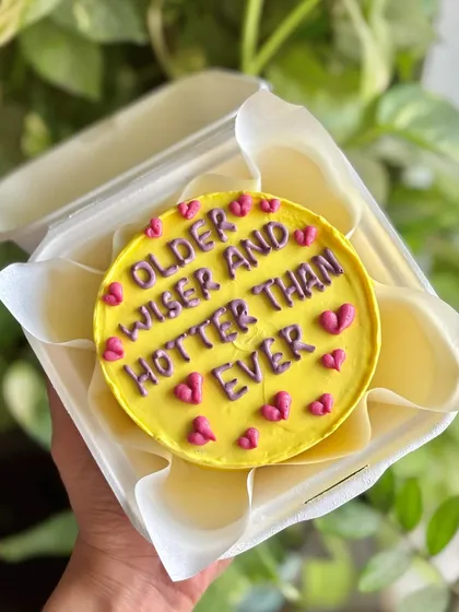 "Older and wiser and hotter than ever." A sassy and fun bento cake in bright yellow and pink, perfect for a confident birthday girl.