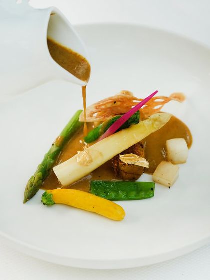 A rich, aromatic broth is poured over the elephant yam and asparagus in our vegetarian nihari, bringing all the elements of the dish together.