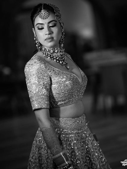 A graceful black and white portrait of the bride, her eyes closed, capturing a moment of serene beauty.