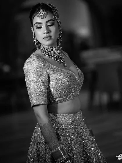 A graceful black and white portrait of the bride, her eyes closed, capturing a moment of serene beauty.