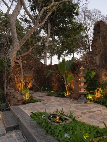 Restoring history at the Sanctuary Bar. I worked with the existing 200-year-old ruins, weaving a landscape of native plants and warm lighting through the historic stone to create an immersive, timeless experience.