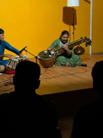 The audience enjoys a soulful performance by talented musicians on the Karmasthan stage. We host these intimate gatherings to celebrate art and build our core community.