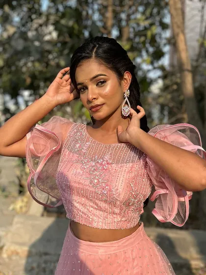 A happy and confident pose, showing how the makeup enhances her natural features and gives her a photo-ready look.