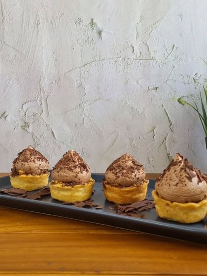 For those who love individual desserts, I offer these chocolate mousse tarts. They have a buttery tart shell filled with airy, rich chocolate mousse and topped with delicate chocolate shavings.